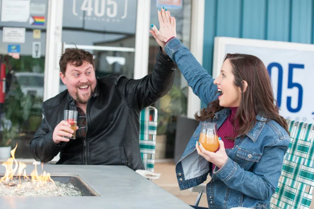 Lia and another model sharing a high five at 405 Brewing