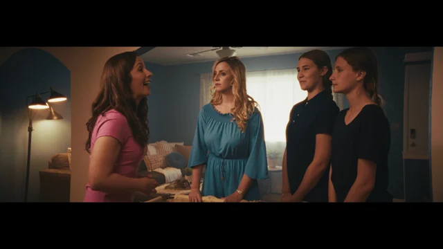 Lia in a scene with three other women